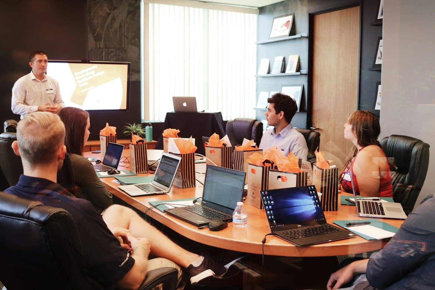 A team being walked through a new system around a meeting table