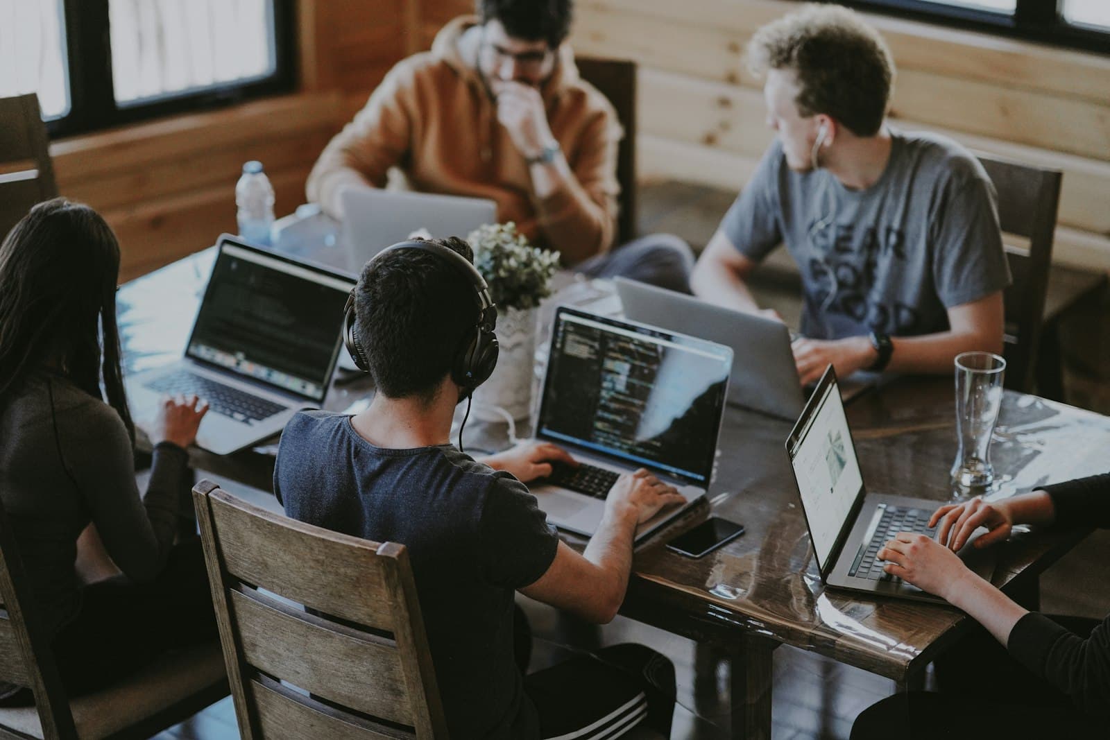 A team working together at laptops around one table